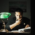 man planning at his desk at night to reduce decision fatigue and organize the next day