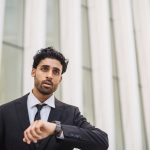 Man checking watch and running late – time blindness concept