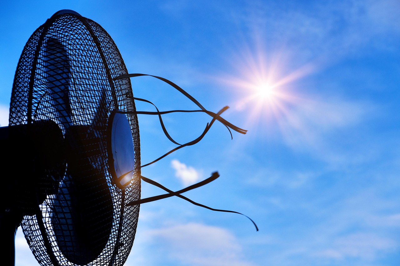 Europe heatwave shown through a broken fan under intense sunlight